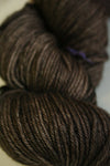 Madelinetosh Tosh DK yarn in Pecan Hull color, showcasing a close-up of soft, hand-dyed wool yarn for knitting or crochet projects.