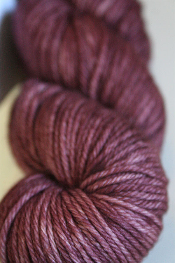 Madelinetosh Tosh DK yarn in dried rose color, soft wool knit skein with rich, warm pink tone for knitting or crochet projects.