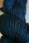 Madelinetosh Tosh DK yarn in deep, rich color, showcasing soft wool texture and vibrant tone for knitting or crochet projects.
