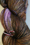 Madelinetosh Tosh DK yarn in dachsund colorway, showing soft, hand-dyed wool skein with rich, warm brown tones.