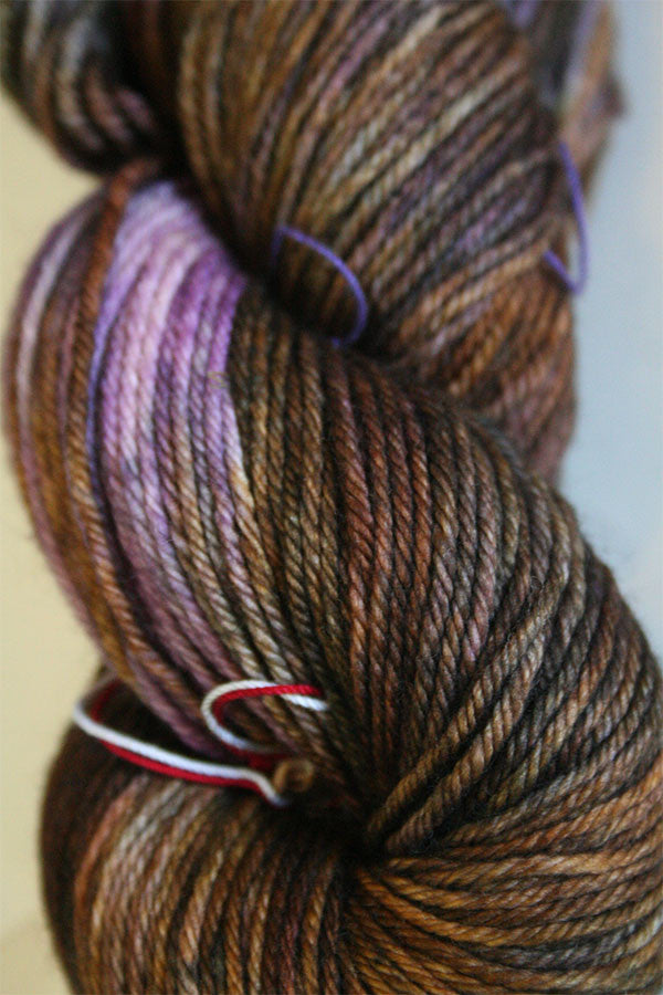 Madelinetosh Tosh DK yarn in dachsund colorway, showing soft, hand-dyed wool skein with rich, warm brown tones.