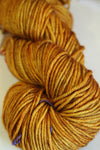 Madelinetosh Tosh DK yarn in Daffodil, showing vibrant yellow color and soft texture of the wool skein.
