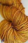 Madelinetosh Tosh DK yarn in Daffodil color, soft wool yarn displayed in a close-up shot showing its vibrant yellow hue.