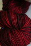 Madelinetosh Tosh DK yarn in tart color, soft wool skein for knitting or crochet projects.