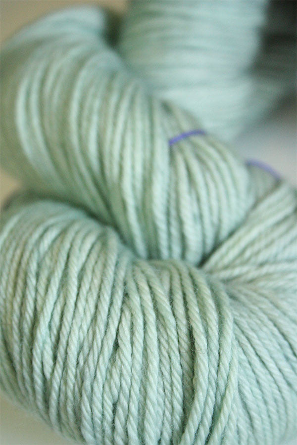 Madelinetosh Tosh DK yarn in Silverleaf color, soft and vibrant wool yarn for knitting and crochet projects.