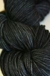 Madelinetosh Tosh DK yarn in leopard print with tan, black, and brown tones, showcasing soft, textured wool yarn for knitting or crochet.