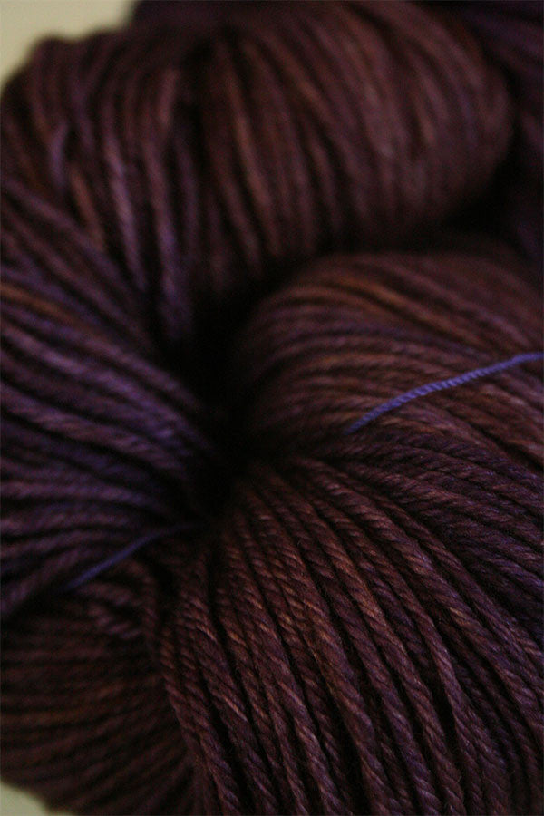 Madelinetosh Tosh DK yarn in Geode colorway, soft wool and nylon blend, showcasing vibrant color variations and texture.