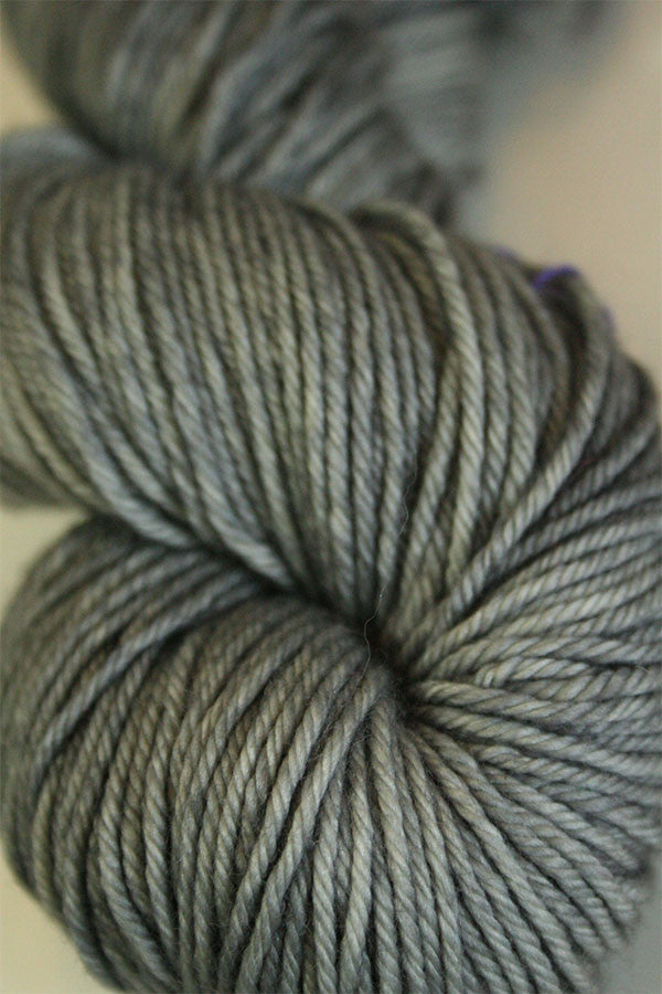 Madelinetosh Tosh DK yarn in Great Grey Owl color, soft and vibrant wool yarn close-up shot.