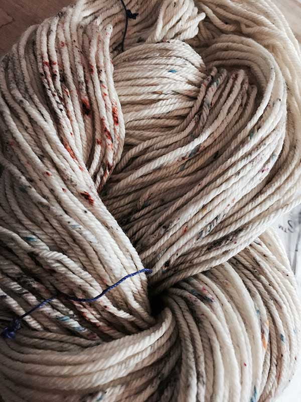 Madelinetosh Tosh DK yarn in a modern fair isle pattern featuring vibrant, multicolored wool on a neutral background.