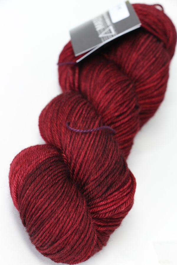 Madelinetosh Tosh DK yarn in Tart colorway, soft and rich wool yarn suitable for knitting and crochet projects.
