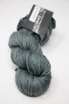 Madelinetosh Tosh DK yarn in Geyser Pool color, soft wool yarn with blue and green tones for knitting or crochet projects.