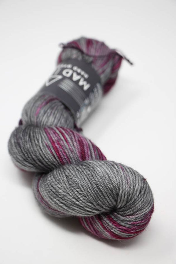 Madelinetosh Tosh DK yarn in Black Velvet, showcasing soft, deep black wool yarn for knitting and crochet projects.