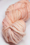 Malabrigo Rasta merino wool yarn in melon color, showcasing thick, soft, and vibrant hand-dyeing for knitting and crochet projects.