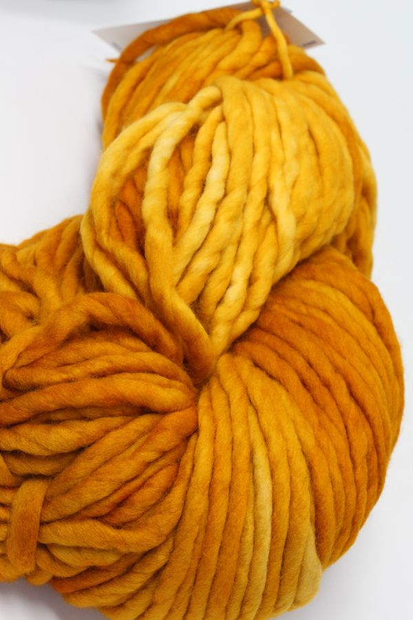 Malabrigo Rasta Merino Wool Yarn in sunset color showcasing vibrant, thick, hand-dyed yarn with a soft, textured appearance.
