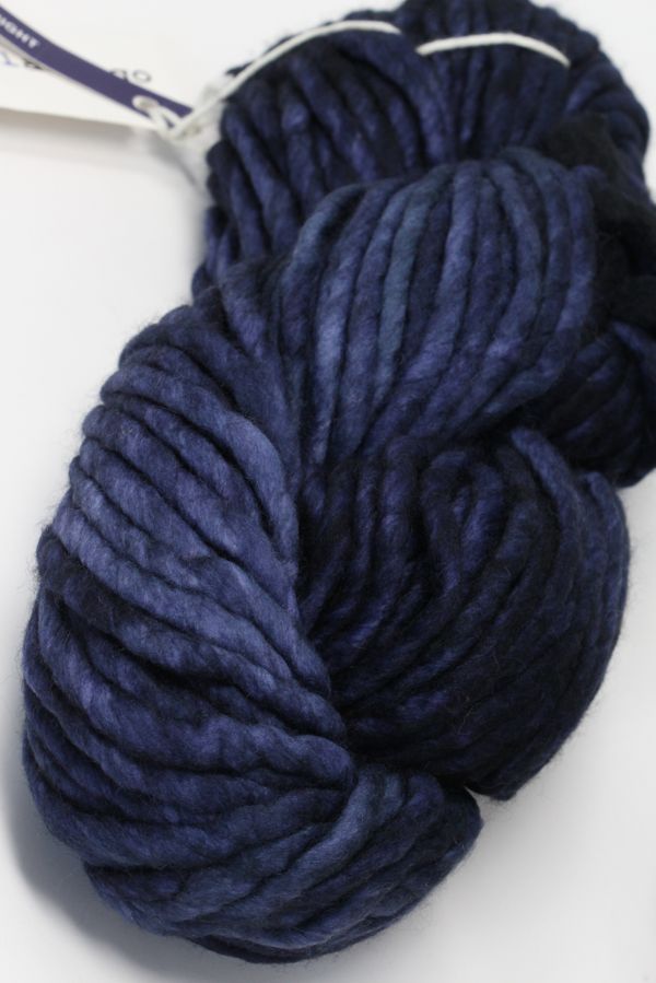 Malabrigo Rasta merino wool yarn in Paris Night color, showing thick, soft, hand-dyed yarn with rich deep purple and black tones.