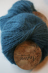 Teal Plymouth Angora Yarn ball showing soft, fluffy texture and branding label, ideal for knitting projects.