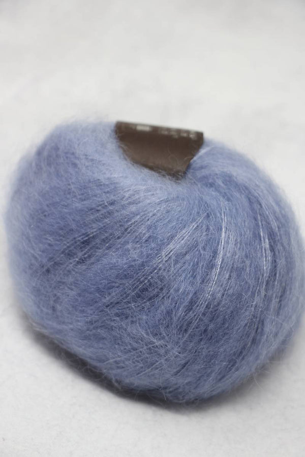 Soft, multicolor Rowan Kidsilk Haze yarn skein in a close-up shot, showing its delicate fibers and vibrant, variegated hues.