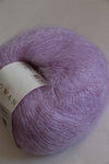 Close-up of Rowan Kidsilk Haze yarn in Hibiscus color, showcasing soft, delicate, multicolored fiber suitable for knitting or crochet projects.