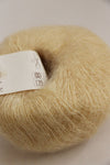 Rowan Kidsilk Haze yarn in vanilla color, showing soft, delicate fiber with a smooth, silky texture for knitting or crochet projects.