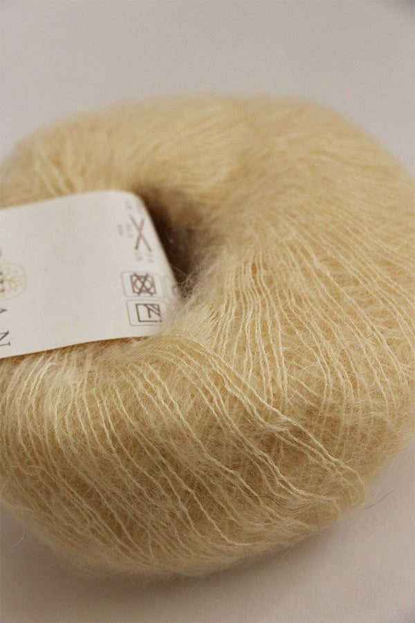 Rowan Kidsilk Haze yarn in vanilla color, showing soft, delicate fiber with a smooth, silky texture for knitting or crochet projects.