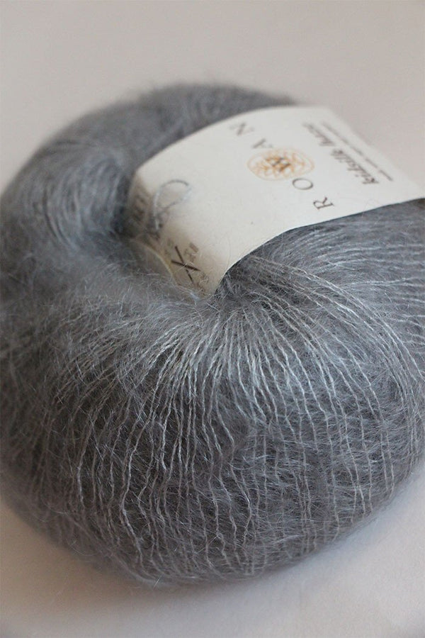 Close-up of Rowan Kidsilk Haze yarn in steel color, showcasing soft, delicate fibers perfect for knitting or crochet projects.
