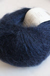 Rowan Kidsilk Haze yarn in Turkish Plum color, showing soft, delicate fibers ideal for knitting or crochet projects.