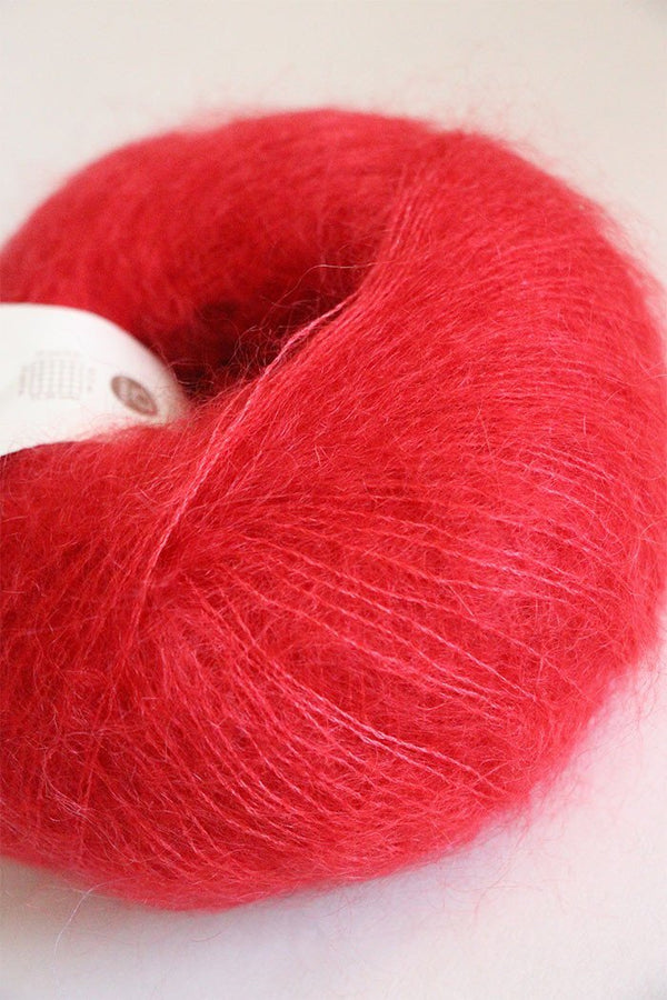 Rowan Kidsilk Haze yarn in rich red color, soft and lightweight fiber ideal for knitting or crochet projects.