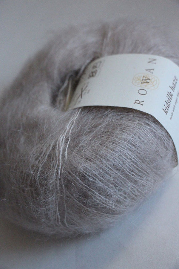 Rowan Kidsilk Haze yarn in soft pearl color, showcasing delicate, lightweight fiber ideal for knitting and crochet projects.