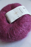 Rowan Kidsilk Haze yarn in soft blush color, showing delicate, lightweight fibers ideal for knitting or crochet projects.