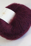 Close-up of Rowan Kidsilk Haze yarn in soft, liqueur color showcasing its delicate, lightweight texture for knitting or crochet projects.