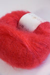 Rowan Kidsilk Haze yarn in warm marmalade color, soft and lightweight fiber ideal for knitting and crochet projects.