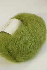 Soft, multicolored Rowan Kidsilk Haze yarn skein with a blend of pastel shades, perfect for delicate knitting projects.