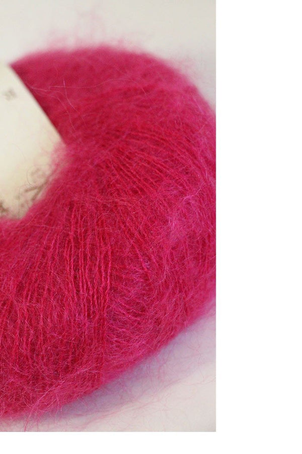 Soft, multicolored Rowan Kidsilk Haze yarn skein showcasing its delicate, fuzzy texture and vibrant pastel shades.