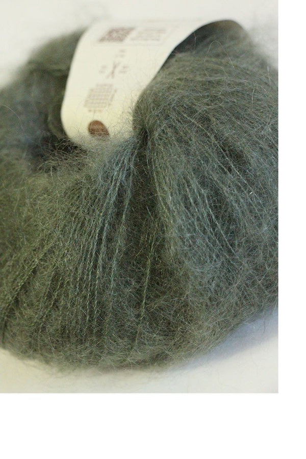 Rowan Kidsilk Haze yarn in drab color, close-up of soft, fine silk and mohair blend suitable for knitting or crochet projects.
