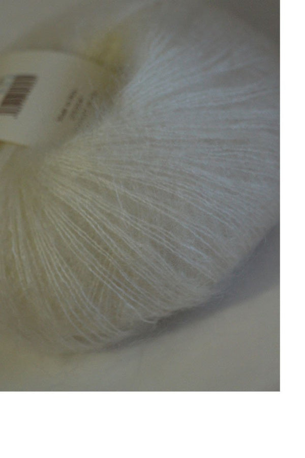 White Rowan Kidsilk Haze yarn ball, soft and delicate fiber for knitting or crochet projects, showcasing its fine texture and color.