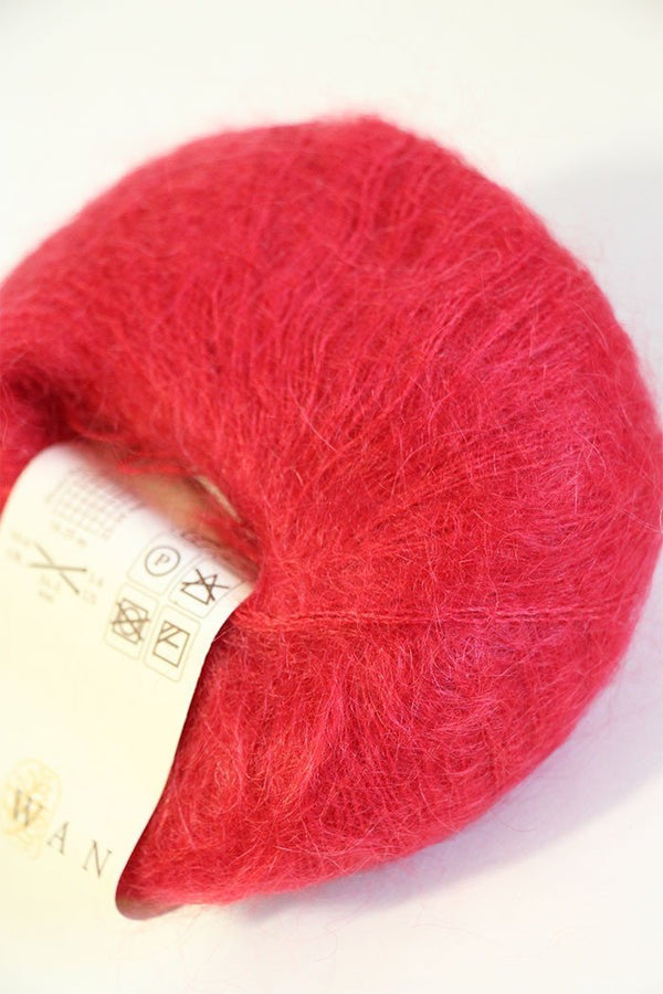 Rowan Kidsilk Haze yarn in strawberry pink, soft and delicate with a smooth texture, ideal for knitting and crochet projects.