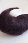 Black Currant Rowan Kidsilk Haze yarn ball showcasing soft, lightweight, multi-purpose knitting and crochet silk and mohair blend.