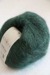 Soft, forest green Rowan Kidsilk Haze yarn ball showcasing its delicate, lightweight silk and mohair blend texture.