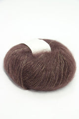 Soft Rowan Kidsilk Haze yarn in bark color, showcasing delicate, lightweight fiber ideal for knitting and crochet projects.