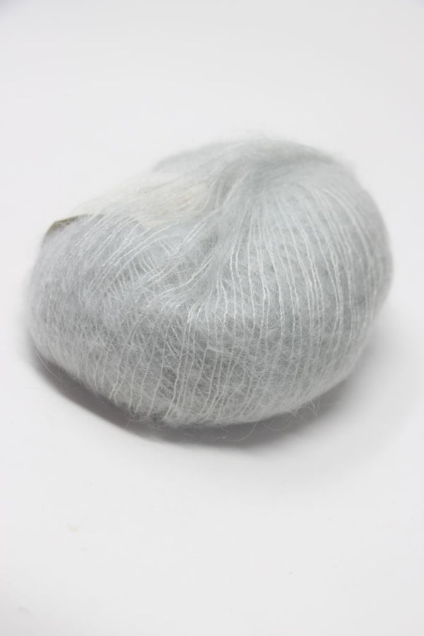 Soft, multicolored Rowan Kidsilk Haze yarn skein in pastel shades, ideal for knitting and crochet projects.