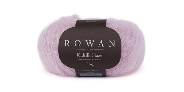 Soft Rowan Kidsilk Haze yarn in a vibrant lilac color, showcasing delicate, lightweight fibers ideal for knitting and crochet projects.