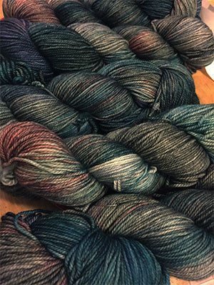 Fingering weight yarn Zen Yarn Garden Serenity 20 in Aquaria, showing vibrant, variegated blue and green yarn skein.