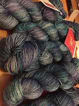 Fingering weight yarn in blue and teal tones from Zen Yarn Garden's Serenity 20 collection, showcasing soft, variegated yarn texture.