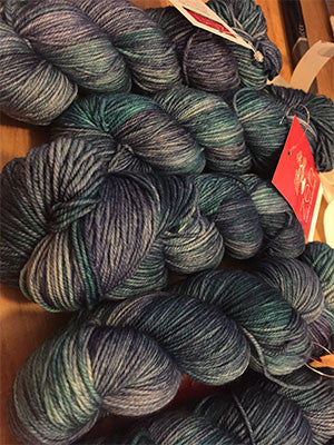 Fingering weight yarn in blue and teal tones from Zen Yarn Garden's Serenity 20 collection, showcasing soft, variegated yarn texture.