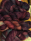 Fingering weight yarn from Zen Yarn Garden's Serenity 20 collection in a vibrant jazzberry color, showcasing soft, smooth fiber.