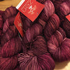 Fingering weight yarn from Zen Yarn Garden's Serenity 20 collection in vibrant Mambo color, showcasing soft, smooth fibers.