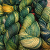 Fingering weight yarn from Zen Yarn Garden's Serenity 20 collection, in soft apple green color, textured and wound into a skein.