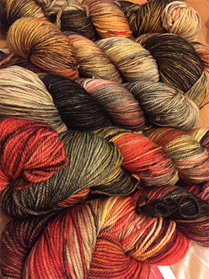 Fingering weight yarn from Zen Yarn Garden's Serenity 20 collection in a colorful, variegated skein with shades of blue, green, and purple.