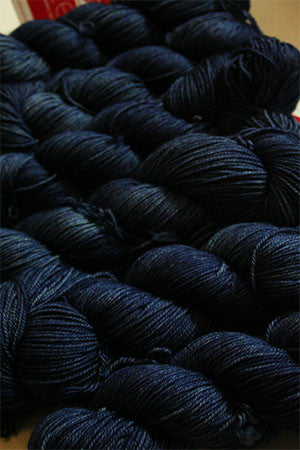 Fingering weight yarn in navy blue from Zen Yarn Garden's Serenity 20 collection, with soft, smooth texture and subtle color variations.