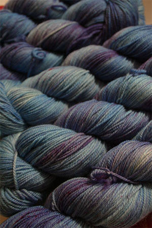 Fingering weight yarn Zen Yarn Garden Serenity 20 in blurple color, showing soft, variegated purple and blue tones.